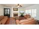 Spacious living room with hardwood floors, fireplace, media center, and natural light at 305 Collegiate Dr, Powder Springs, GA 30127