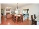 Spacious living room leading into dinning area and sunroom with open floor plan and hardwood floors at 305 Collegiate Dr, Powder Springs, GA 30127