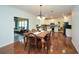 Open floor plan, dinning area, with hardwood floors, leading into a bright kitchen at 305 Collegiate Dr, Powder Springs, GA 30127