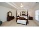 Main bedroom features a tray ceiling, ceiling fan, and furniture at 305 Collegiate Dr, Powder Springs, GA 30127