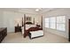 Main bedroom with a tray ceiling, windows, and dark wooden furniture at 305 Collegiate Dr, Powder Springs, GA 30127