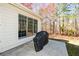 View of a back patio with a covered grill next to a house with large windows at 305 Collegiate Dr, Powder Springs, GA 30127