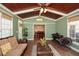 Lovely sunroom with wooden beamed ceiling opens to dining room at 305 Collegiate Dr, Powder Springs, GA 30127