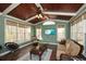 Inviting sunroom with wood paneled ceiling, multiple windows, and comfortable seating at 305 Collegiate Dr, Powder Springs, GA 30127