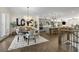 Open floor plan features a dining area with stylish chandelier and modern kitchen with gray cabinetry at 4336 Walsh Dr, Dunwoody, GA 30338