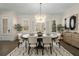 Elegant dining room featuring a modern chandelier, stylish rug, and an abundance of natural light at 4336 Walsh Dr, Dunwoody, GA 30338