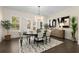 Chic dining room with modern chandelier, designer rug, and natural light creating a cozy atmosphere at 4336 Walsh Dr, Dunwoody, GA 30338