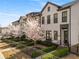 Charming townhome showcases blooming trees, landscaped yard, and a welcoming entrance at 4336 Walsh Dr, Dunwoody, GA 30338