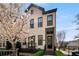 Charming two-story home featuring a blooming tree, manicured landscaping, and a welcoming front entrance at 4336 Walsh Dr, Dunwoody, GA 30338