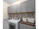 Efficient laundry room with modern washer, dryer, and ample cabinet storage at 4336 Walsh Dr, Dunwoody, GA 30338