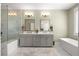 Luxurious main bathroom with a double sink vanity, soaking tub, and separate glass shower at 4336 Walsh Dr, Dunwoody, GA 30338