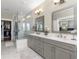 Elegant bathroom with double vanity, glass shower, and view into walk-in closet at 4336 Walsh Dr, Dunwoody, GA 30338