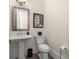 Well-appointed powder room featuring stylish fixtures, pedestal sink, and tasteful decor at 4336 Walsh Dr, Dunwoody, GA 30338