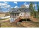 View of the home's back exterior with a deck, screened-in porch, and landscaped yard at 4382 Conwhey Sw Ct, Smyrna, GA 30082
