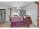 Charming dining space featuring a wooden table set for four, stainless steel appliances, and neutral walls at 4382 Conwhey Sw Ct, Smyrna, GA 30082
