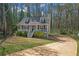 Charming home with a front porch, landscaped yard, and a driveway, enveloped by mature trees providing natural shade at 4382 Conwhey Sw Ct, Smyrna, GA 30082