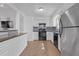 Bright kitchen with white cabinets, dark countertops, and stainless steel appliances, creating a modern and functional space at 4382 Conwhey Sw Ct, Smyrna, GA 30082
