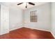 Bedroom with hardwood floors, fan and natural light from the window at 6962 Oakhill Cir, Austell, GA 30168