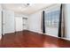A simple bedroom featuring hardwood floors, a window, and a closet with sliding doors at 6962 Oakhill Cir, Austell, GA 30168