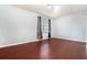 Bright bedroom with hardwood floors, neutral paint, and a window with curtain at 6962 Oakhill Cir, Austell, GA 30168