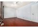 Bright bedroom with hardwood floors, neutral paint, and a window with curtain at 6962 Oakhill Cir, Austell, GA 30168