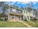 Inviting townhome with a brick and siding exterior, a covered front porch and landscaped lawn at 6962 Oakhill Cir, Austell, GA 30168