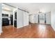 Spacious living room with wood floors, fan, and easy access to kitchen with modern appliances at 6962 Oakhill Cir, Austell, GA 30168
