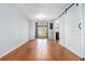 Open living space with wood-look floors, patio access, and a sliding barn door at 6962 Oakhill Cir, Austell, GA 30168