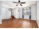 Bright living room featuring wood-look flooring, a ceiling fan, and a large window with curtains at 6962 Oakhill Cir, Austell, GA 30168
