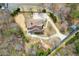 Aerial view of a house with a long driveway and a neatly maintained lawn surrounded by mature trees at 2845 Echols Rd, Cumming, GA 30041