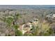 Aerial view capturing the home's setting amidst a wooded area with a winding driveway at 2845 Echols Rd, Cumming, GA 30041