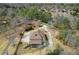 Aerial view displaying a residence with a large deck, surrounded by lush trees and a sprawling driveway at 2845 Echols Rd, Cumming, GA 30041