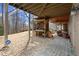 View of a backyard featuring under deck storage for firewood, lawn care supplies, and outdoor equipment at 2845 Echols Rd, Cumming, GA 30041