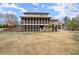Exterior view displaying a large, screened-in porch and a well-maintained backyard at 2845 Echols Rd, Cumming, GA 30041