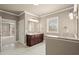 Bathroom featuring a marble vanity, generous counter space, and a bright window for natural light at 2845 Echols Rd, Cumming, GA 30041