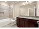 Neutral bathroom with a tub-shower featuring tile surround, granite vanity, and a classic white toilet at 2845 Echols Rd, Cumming, GA 30041