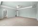 Airy bedroom featuring a fan, a tray ceiling, neutral carpet and access to a walk in closet at 2845 Echols Rd, Cumming, GA 30041