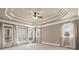 Bedroom with tray ceiling, carpet floors, neutral walls, and bright windows with flowing curtains at 2845 Echols Rd, Cumming, GA 30041