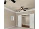 Bedroom showcasing double doors and a ceiling fan, featuring neutral walls and carpet at 2845 Echols Rd, Cumming, GA 30041