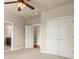 Bedroom with double doors and an open door to the bathroom, featuring neutral walls and carpet at 2845 Echols Rd, Cumming, GA 30041