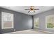 Grey bedroom with two windows and a ceiling fan provides a serene and inviting atmosphere at 2845 Echols Rd, Cumming, GA 30041