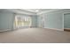 Spacious bedroom with neutral carpet, tray ceiling, and large window with natural light at 2845 Echols Rd, Cumming, GA 30041