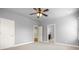 Neutral bedroom with carpet, ceiling fan, and two entryways to the hallway and attached bath at 2845 Echols Rd, Cumming, GA 30041