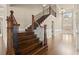 Grand foyer featuring hardwood floors, staircase with iron spindles, and elegant lighting fixtures at 2845 Echols Rd, Cumming, GA 30041