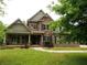Charming two-story home featuring a stone and brick facade, a well-manicured lawn, and a welcoming front porch at 2845 Echols Rd, Cumming, GA 30041