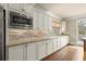 Bright kitchen featuring stainless steel appliances, granite counters, a brick backsplash, and generous cabinets at 2845 Echols Rd, Cumming, GA 30041