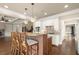 Bright kitchen featuring an island with bar seating, granite counters, stainless appliances, and white cabinetry at 2845 Echols Rd, Cumming, GA 30041