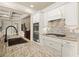 Close-up of modern kitchen featuring granite countertops, subway tile backsplash, and stainless steel appliances at 2845 Echols Rd, Cumming, GA 30041