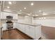 Open kitchen boasts white cabinets, granite countertops, and stainless steel appliances at 2845 Echols Rd, Cumming, GA 30041
