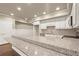 Open kitchen design with granite countertops and stainless steel appliances at 2845 Echols Rd, Cumming, GA 30041